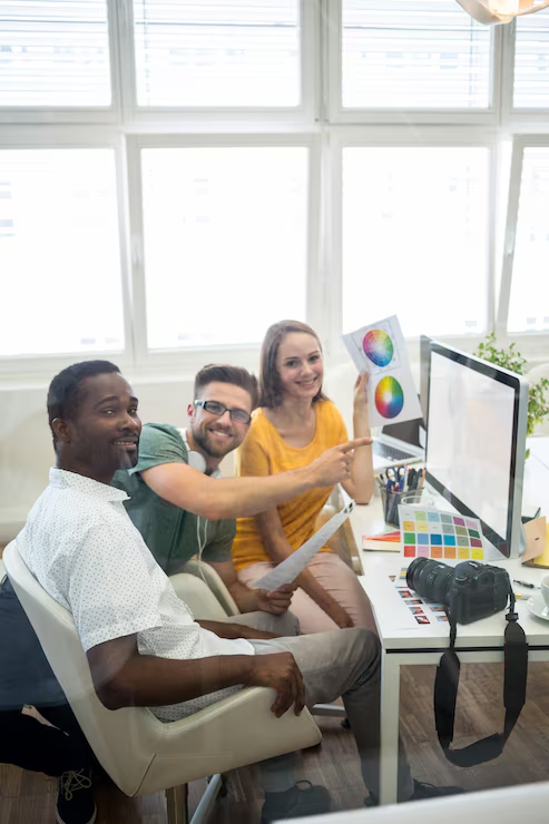 Team reviewing creative work at a shared desk